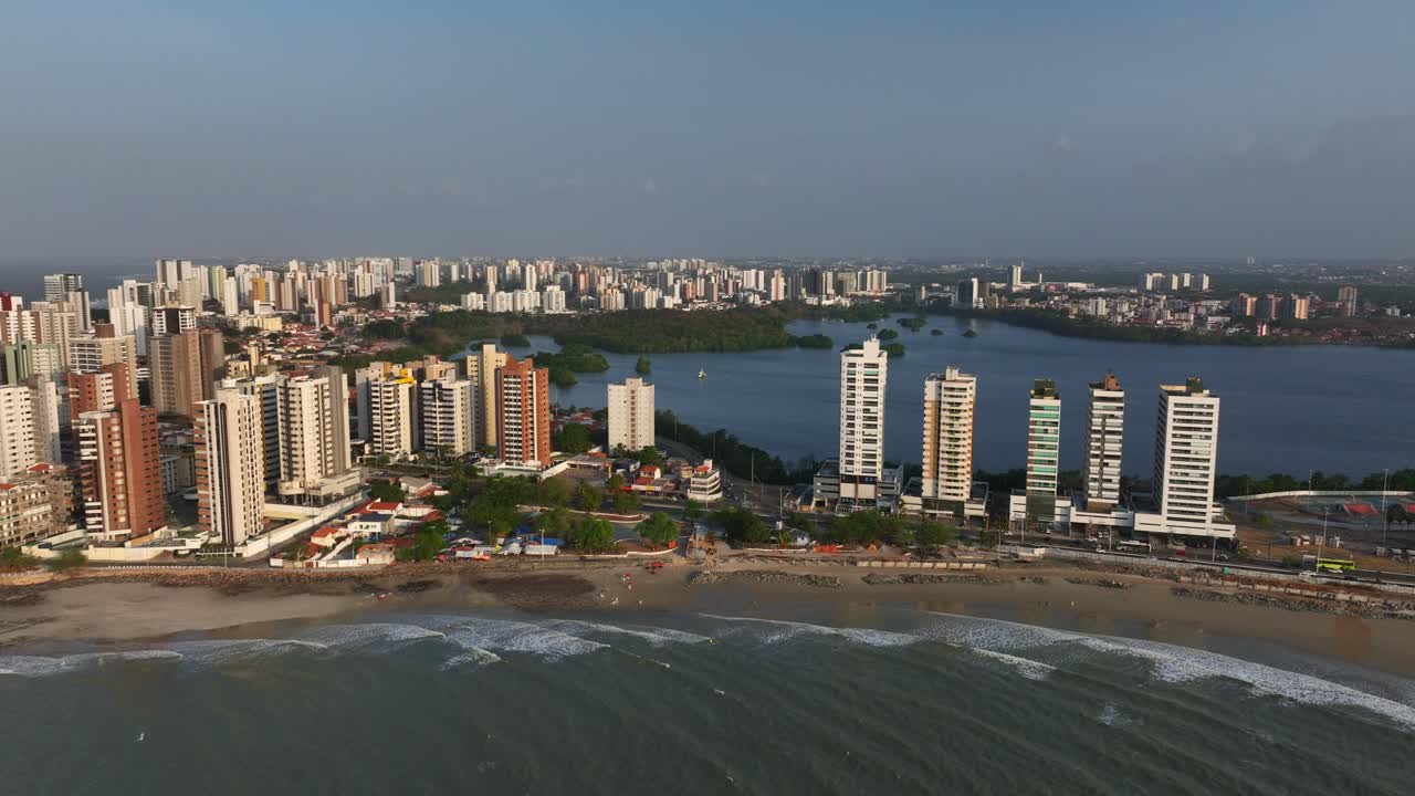 Beachfront skyline of São Luís, Brazil, with ocean waves and modern tall buildings