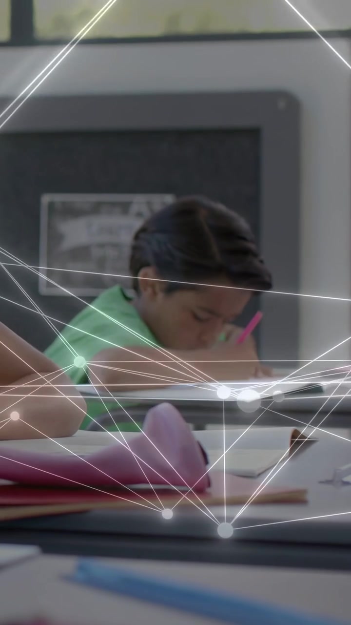Vertical video: Child writing in class, starting work and activating animated net lines on notebook