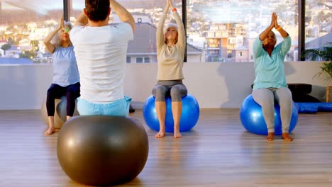 trainer and senior women performing yoga 4k