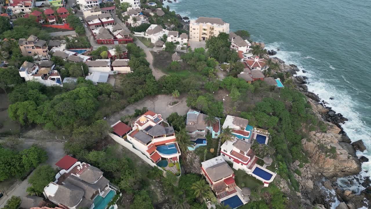 Coastal real estate in Puerto Escondido, Oaxaca, Mexico, bird's-eye view of beachfront residences, houses, and hotels