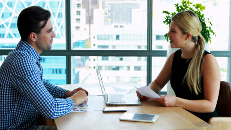 executives interacting with each other at desk