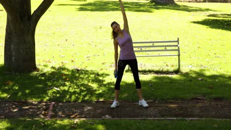 Runner-stopping-to-stretch-out-in-the-park