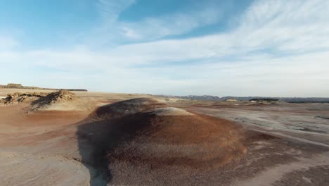 fast-racing-shot-flying-over-Bentonite-hills-in-hankesville-utah-60fps