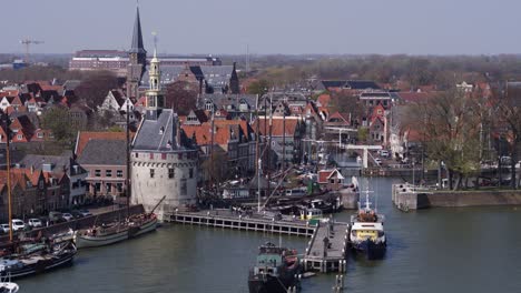 Group-of-people-exploring-old-promenade-in-medieval-town-Hoorn---aerial-crane