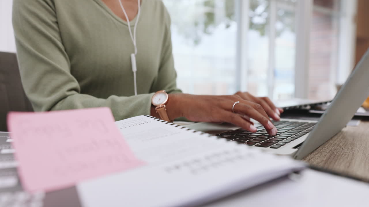 Business person typing email on laptop