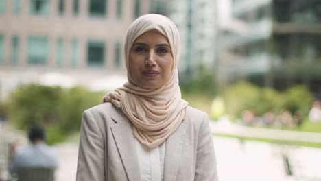 Portrait-Of-Muslim-Businesswoman-Outdoors-Standing-In-Front-Of-City-Offices