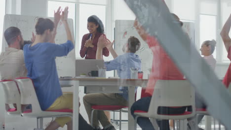 Through-glass-people-applauding-african-woman.-Colleagues-celebrating-success.