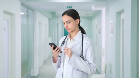 indian female doctor using phone