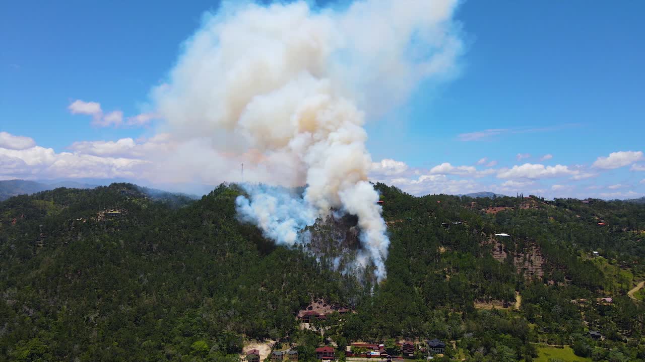 montaña bajo fuego, destrucción de la naturaleza y la vida silvestre por parte del ser humano, impresionante rastro de humo en el cielo, vista aérea de una montaña en llamas