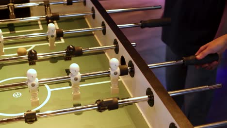 players engaged in a foosball match