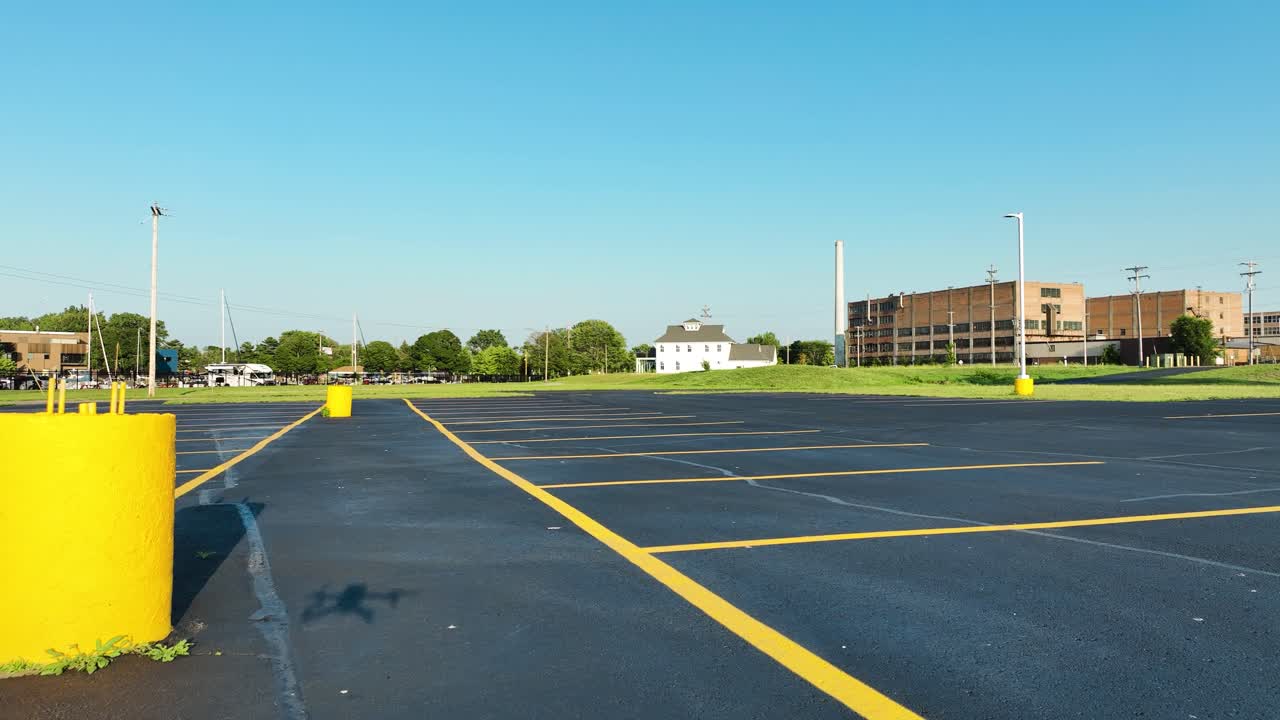 Pedestal motion downward over a blacktop parking lot with crisp lines
