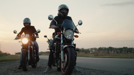 a group of bikers climb on their motorcycles and drive off 1