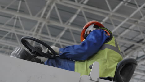 worker operating industrial vehicle in a warehouse