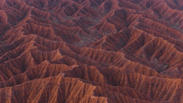 Red Sandstone Cliffs Carved By Water Erosion In The Ak-Sai Canyon In Kyrgyzstan, Central Asia. Aerial Drone Shot