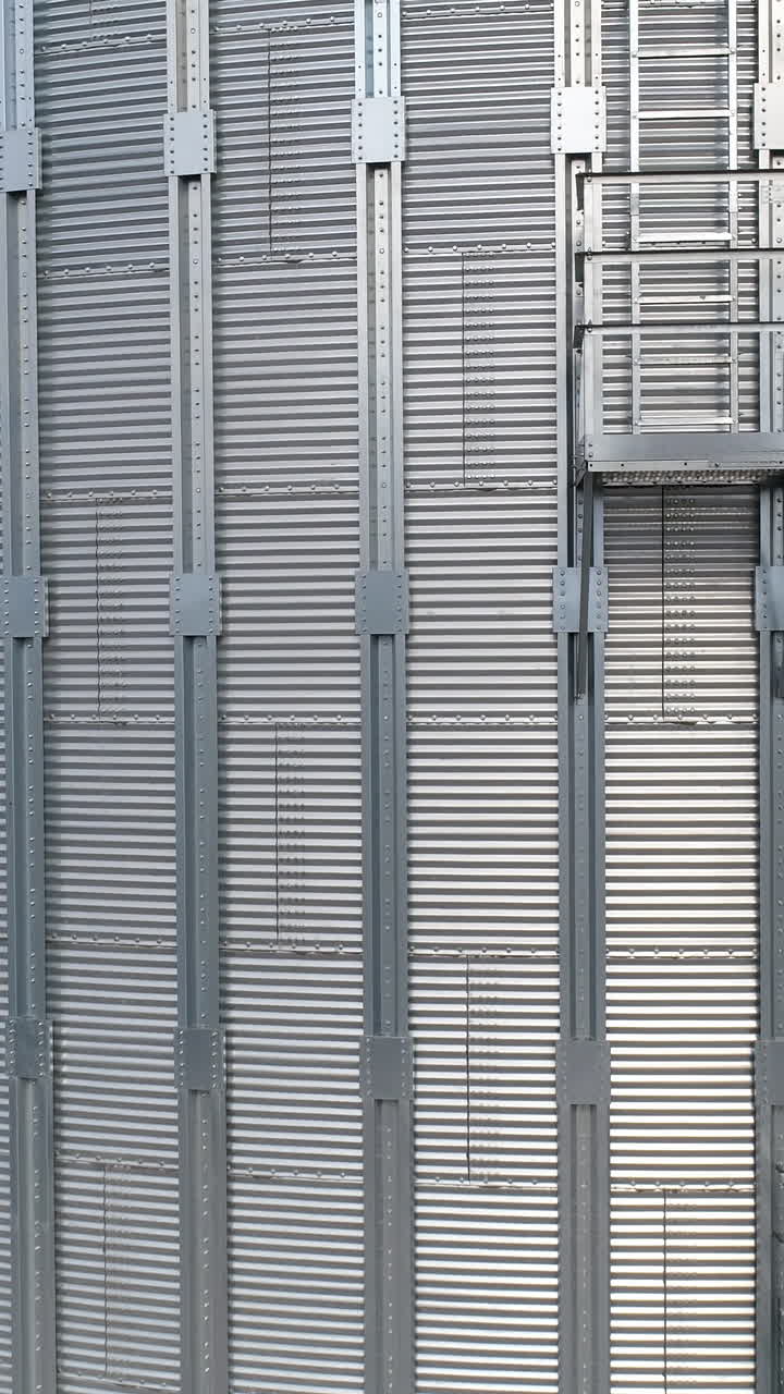 Metal grain industrial factory storage. Agricultural tank storehouse. Aerial view. Vertical video