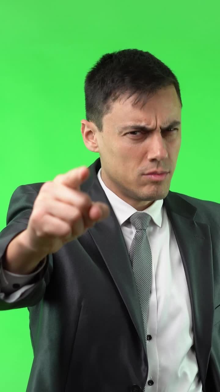 Man in Suit Pointing on Green Screen