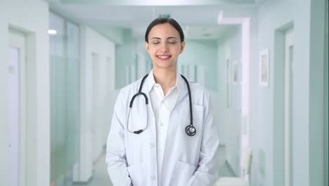 happy indian female doctor smiling to the camera