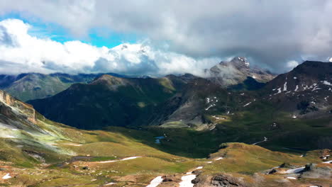 aerial hyper lapse of a beautiful green valley with clouds passing in the sky