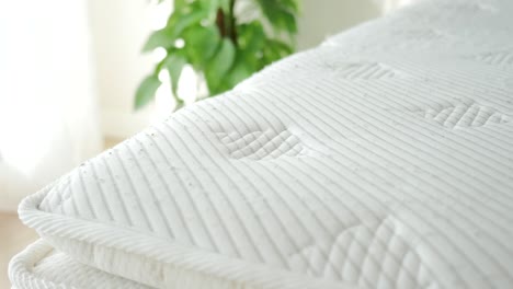 hand pressing on a mattress