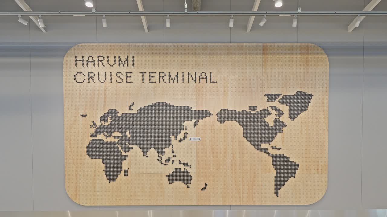 Modern interior of Harumi Cruise Terminal in Tokyo, Japan, featuring a light wood wall with a world map sign