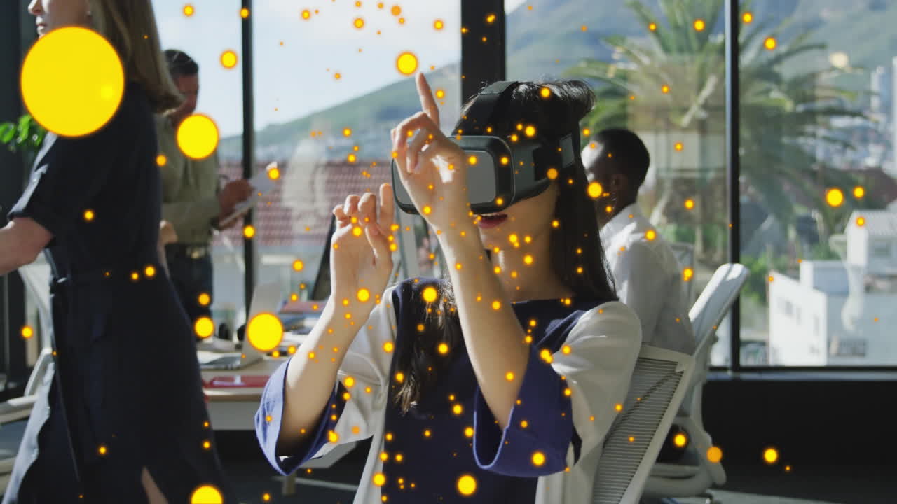 In office, person using VR headset with glowing orange particles animation