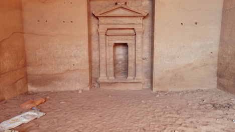 Tilt-up-shot-of-carved-doorway,-Petra-archaeological-Park,-Jordan