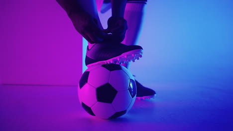 close - up of a soccer ball at the feet of a football player in the studio in slow motion . professional football player with a ball in the studio