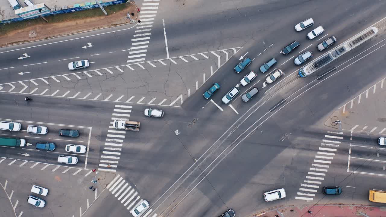 Aerial view of a busy intersection with cars and pedestrians
