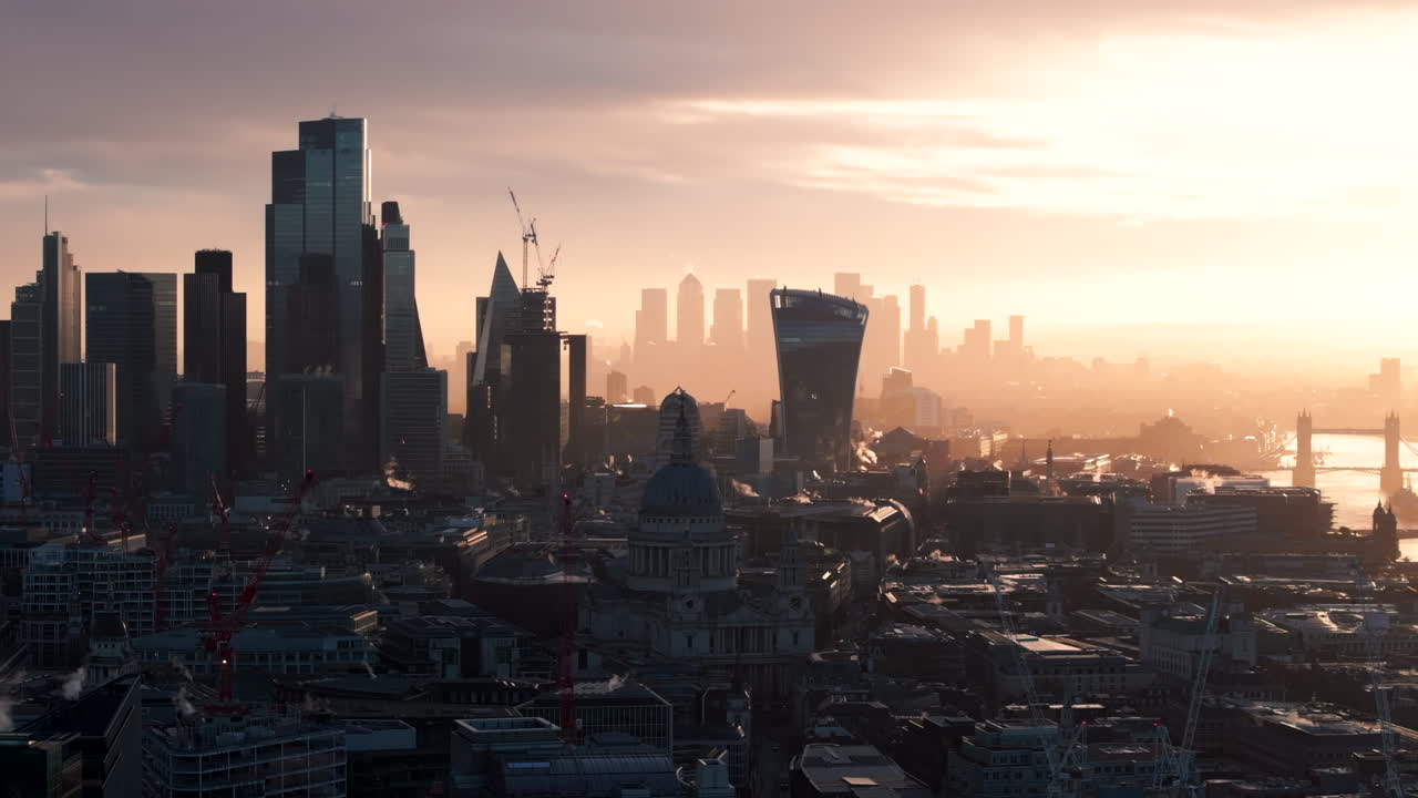 Aerial slider shot of central London with Canary wharf in the background at sunrise