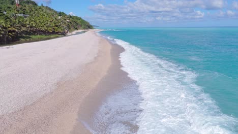 waves of caribbean sea reaching playa los patos in barahona at sunny day