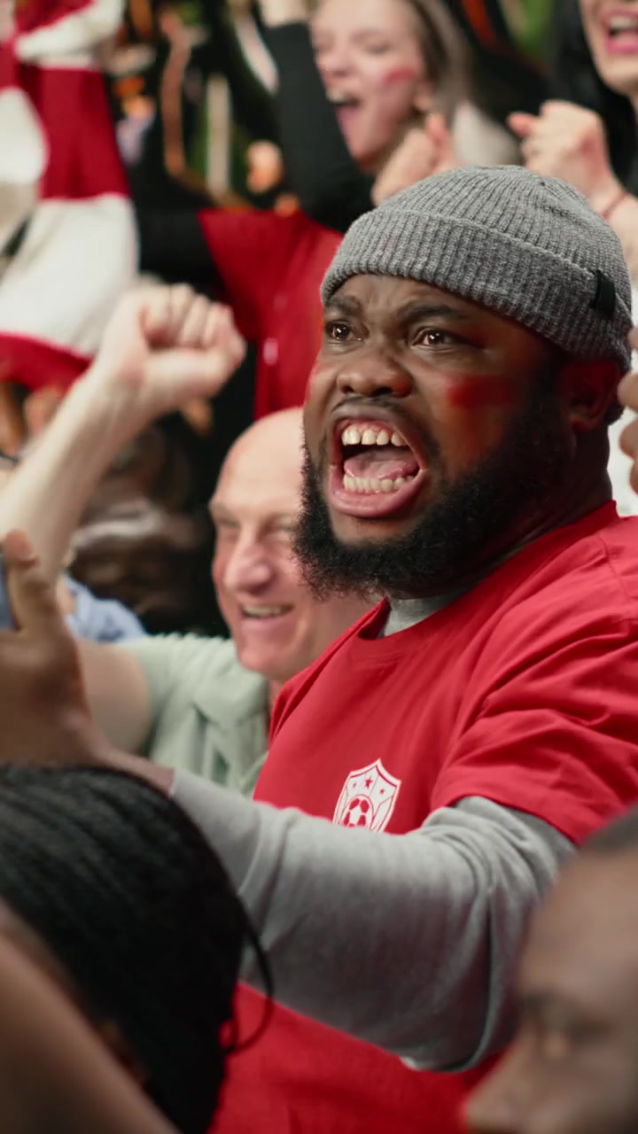 Vertical Video Shocked supporter celebrating high stakes betting win on mobile betting app