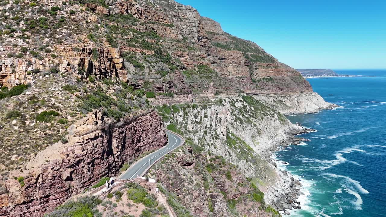 Aerial drone footage of Chapman's Peak Drive, a stunning winding coastal road between Hout Bay and Noordhoek with breathtaking Atlantic Ocean