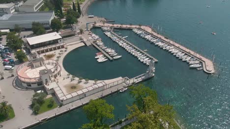 beautiful drone view of the marina and the blue water of the gardalake in riva del garda, a small town in the region of trentino alto adige in north italy