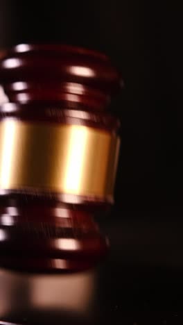 close-up of gavel striking in courtroom, symbolizing justice and legal authority. vertical video