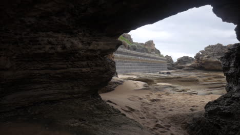 Walk-though-of-eroded-rock-formations-on-an-Australian-beach