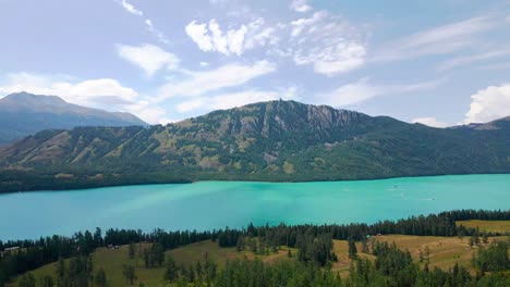 aerial establishing dolly of stunning kanas lake, xinjiang china ecopark, midday