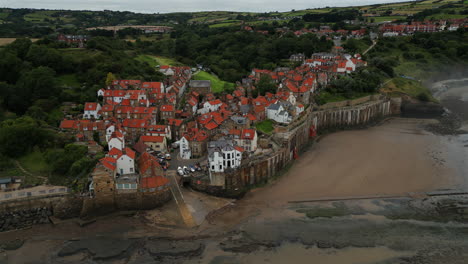 establishing drone shot over robin hood's bay at low tide