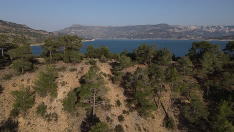 Aerial-view-by-drone-of-the-fields-in-a-canyon-towards-the-valley,-valley-view-over-the-cliffs,-overhead-view-of-the-top-of-the-mountains