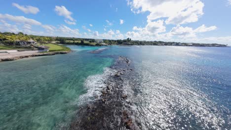 high speed fpv fly over caleton beach, casa de campo la romana, dominican republic. the blue bay and white sand beach.