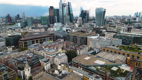 london uk, revealing aerial view of downtown skyscrapers from river thames, tilt up drone shot