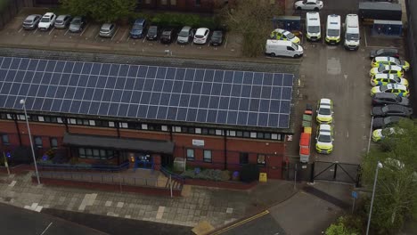 Widnes-town-police-station-with-solar-panel-renewable-energy-rooftop-in-Cheshire-townscape-aerial-view-orbiting-car-park