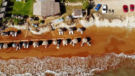 Tourists-Lounging-By-The-Beach-In-Megas-Lakkos,-Kefalonia-Greece---Aerial-shot