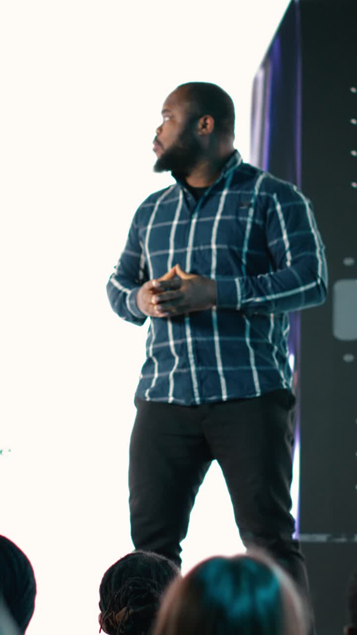 Vertical Video African american lead engineer revealing new smartphone launch with presentation