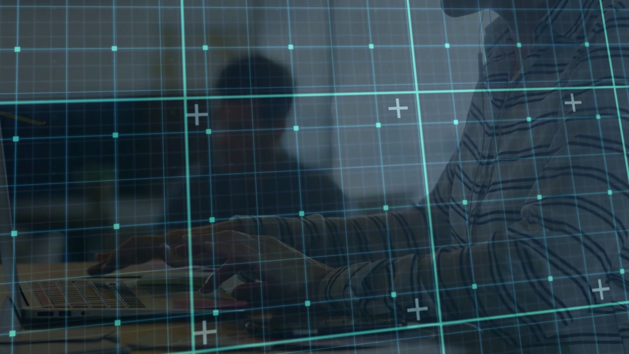 Man leaning forward hands on laptop in office, teal grid overlaying tech UI while preparing slides