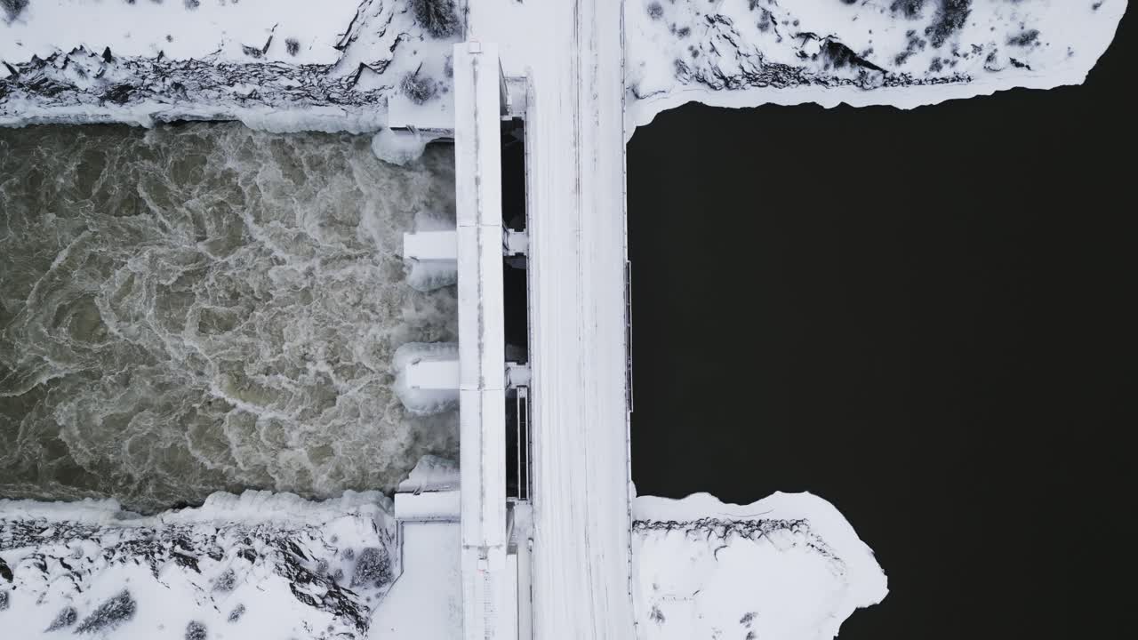 Close Up Slow Establishing Shot Aerial Drone View Rushing Water Notigi Hydro Dam River Snowy Landscape Northern Winter Manitoba Canada