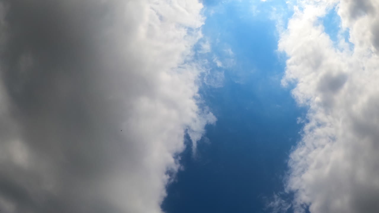 Clouds timelapse in the sky. Watch as thick clouds move and shift dramatically in the sky over time, creating a dynamic atmosphere