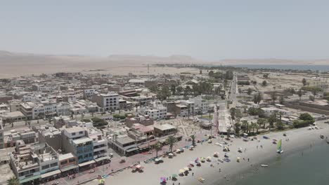 flyover of small coastal desert town of paracas on peru's mid-coast