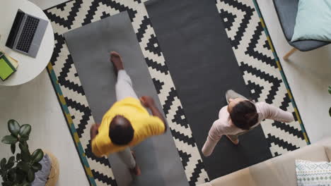 couple practicing yoga together at home