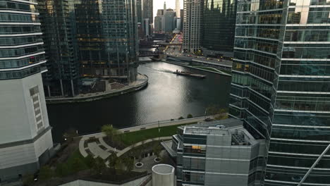 Aerial-view-rising-in-middle-of-skyscrapers-at-the-Wolf-point,-sunset-in-Chicago