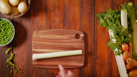 top shot cutting vegetable older hands